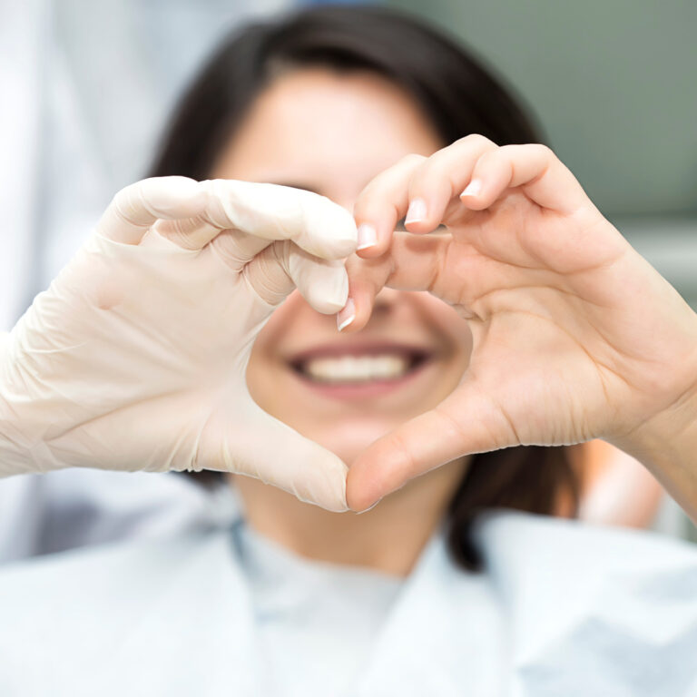 Orthodontist With Patient Making Heart Shape With Her Hands