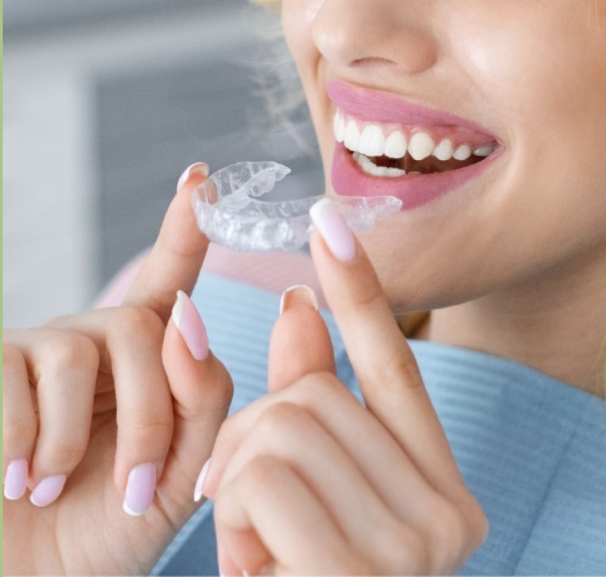 Woman Placing Clear Retainer In Mouth