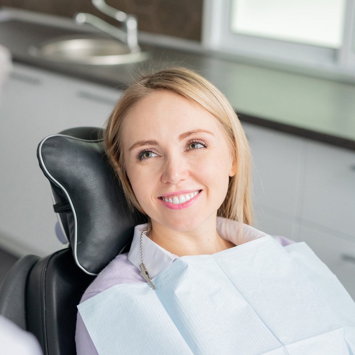 Smiling Woman In Orthodontist Chair